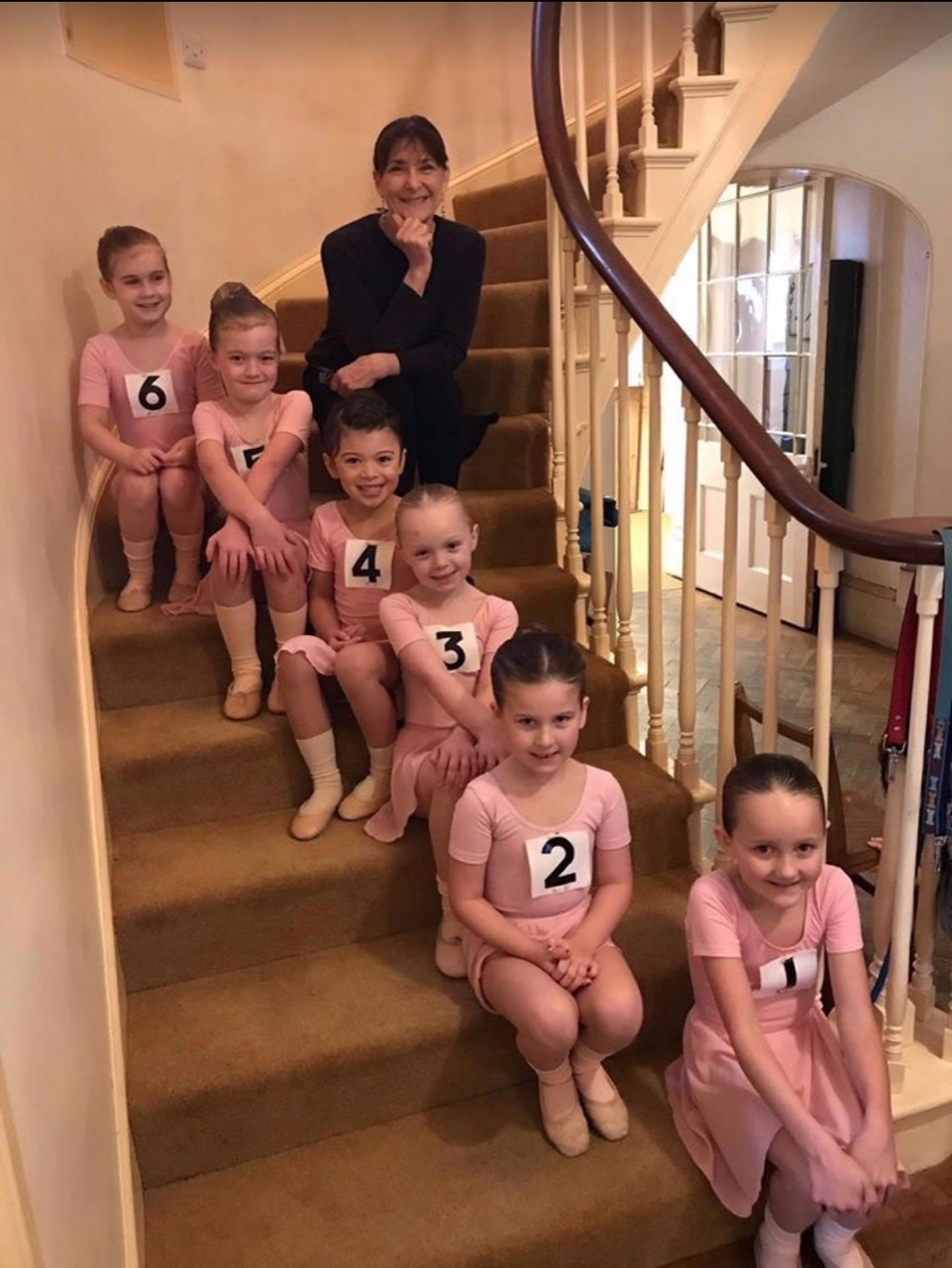 Young ballet students with their teacher