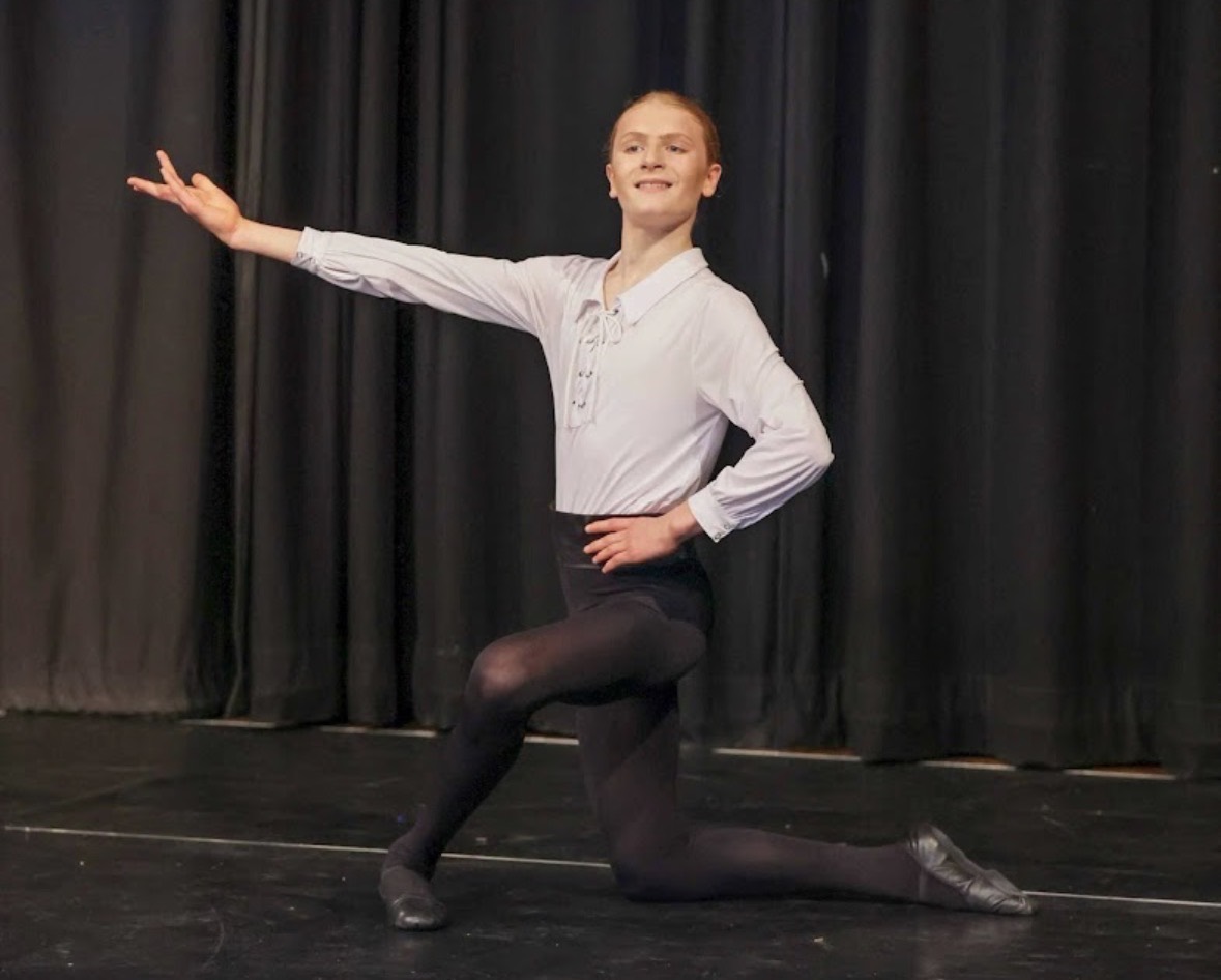 Boy ballet dancer performing on stage