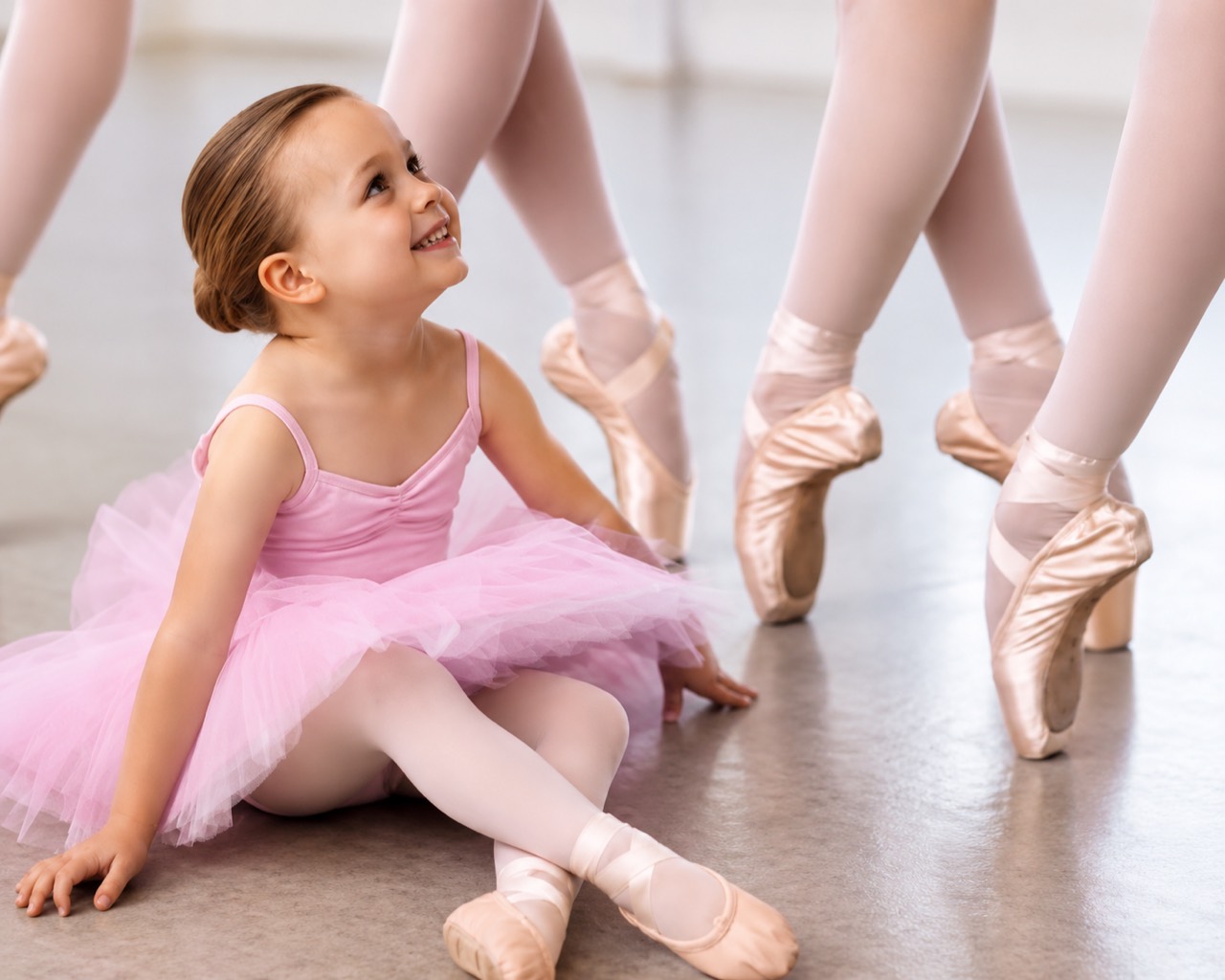 Young child in ballet class with pointe dancers